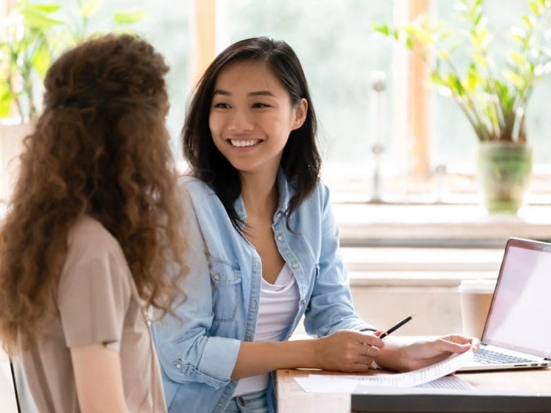 two women chatting at work