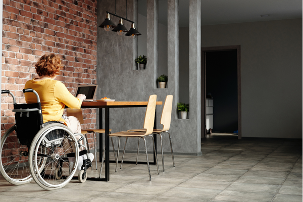 A woman with a disability works in an open office.