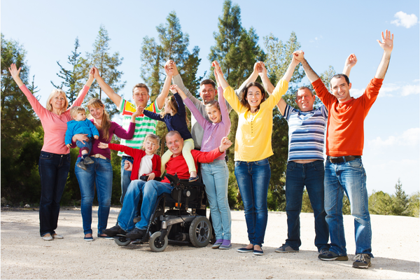 A group of people, including those with disabilities, enjoying time outdoors