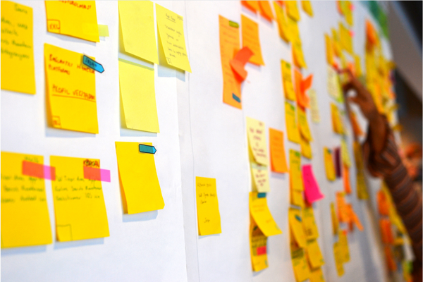 a bunch of sticky notes on a whiteboard